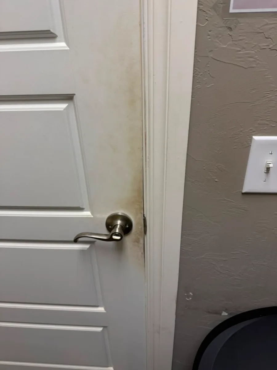 Before cleaning — grime around door handle and frame
