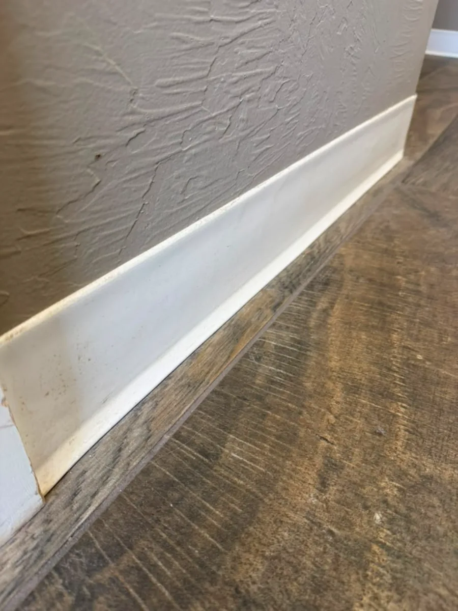 Before cleaning — scuffed and dirty baseboard